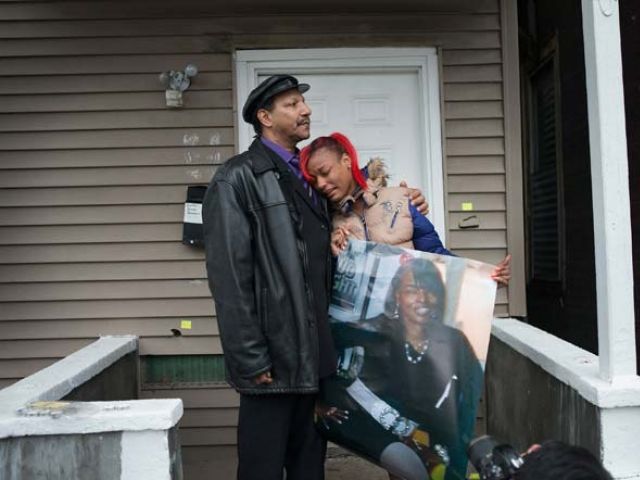 CHICAGO IL- DECEMBER 27 La Tonya Jones the daughter of Bettie Jones gets comfort from her father Garry Mullen during a vigil to honor Bettie a 55-year-old mother of 5