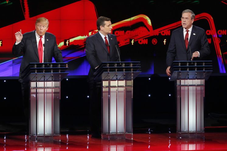 Donald Trump left and Jeb Bush right talk over one another as Ted Cruz listens during the CNN Republican presidential debate Tuesday at the Venetian Hotel and Casino in Las Vegas. Bush said Trump’s proposals can’t be taken seriously