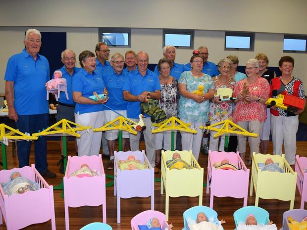 Residents at Living Choice Kawana Island present handmade toys to the Salvation Army for Christmas