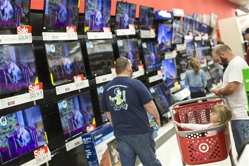 A child rests in a shopping cart in the electronics section against a backdrop of televisions at a Target store Friday Nov. 27 2015 in Newport Ky