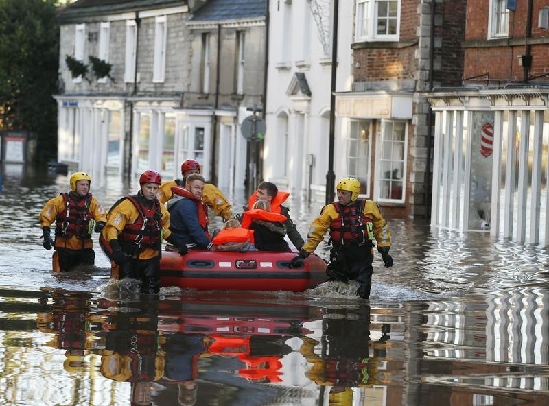 ReutersMembers of the emergency services rescue a group of people from a flooded street in Tadcaster