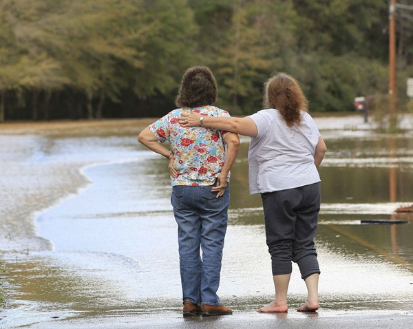 ReutersTwo residents console each other after floodwaters enter their neighborhood in Elba Alabama on Dec. 26 2015