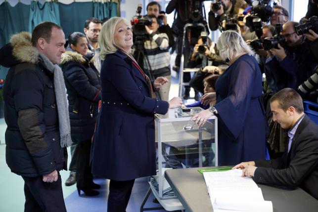 Marine Le Pen, French National Front political party leader and candidate for the National Front in the Nord-Pas-de-Calais-Picardie region casts her ballot in the second-round regional elections in Henin-Beaumont France