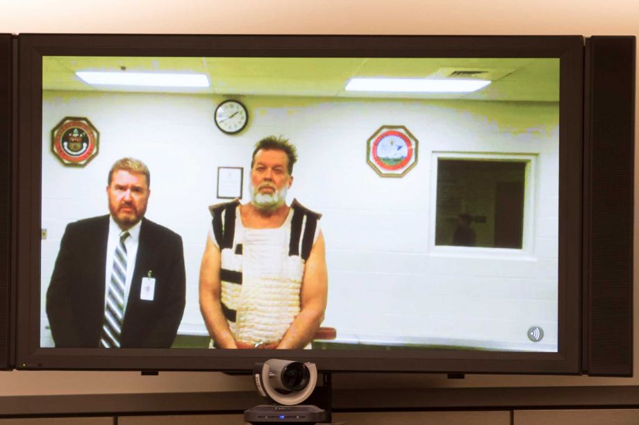 Colorado Springs Planned Parenthood shooting suspect Robert Dear right appears via video hearing Monday standing next to public defender Dan King during Dear's first court appearance where he was told he faces first degree murder charges,﻿ in Colorad