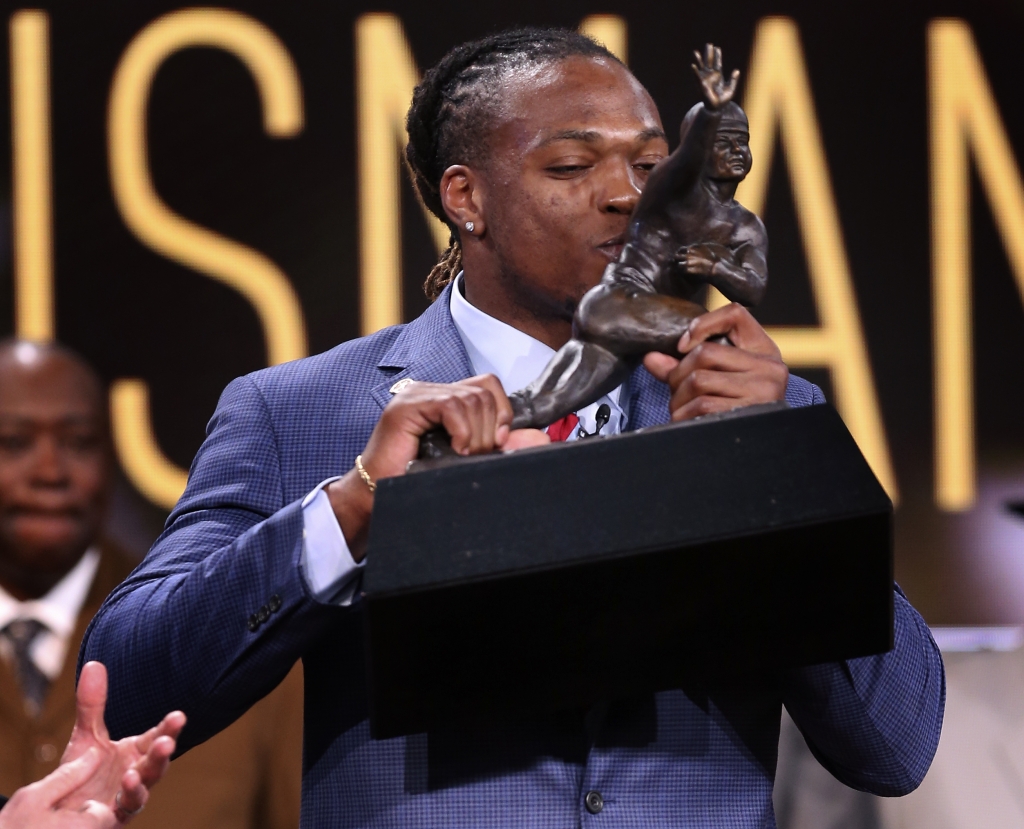 Alabama's Derrick Henry kisses the Heisman Trophy after being announced as the winner of the award which recognizes college football's best player of the year Saturday Dec. 12 2015 in New York