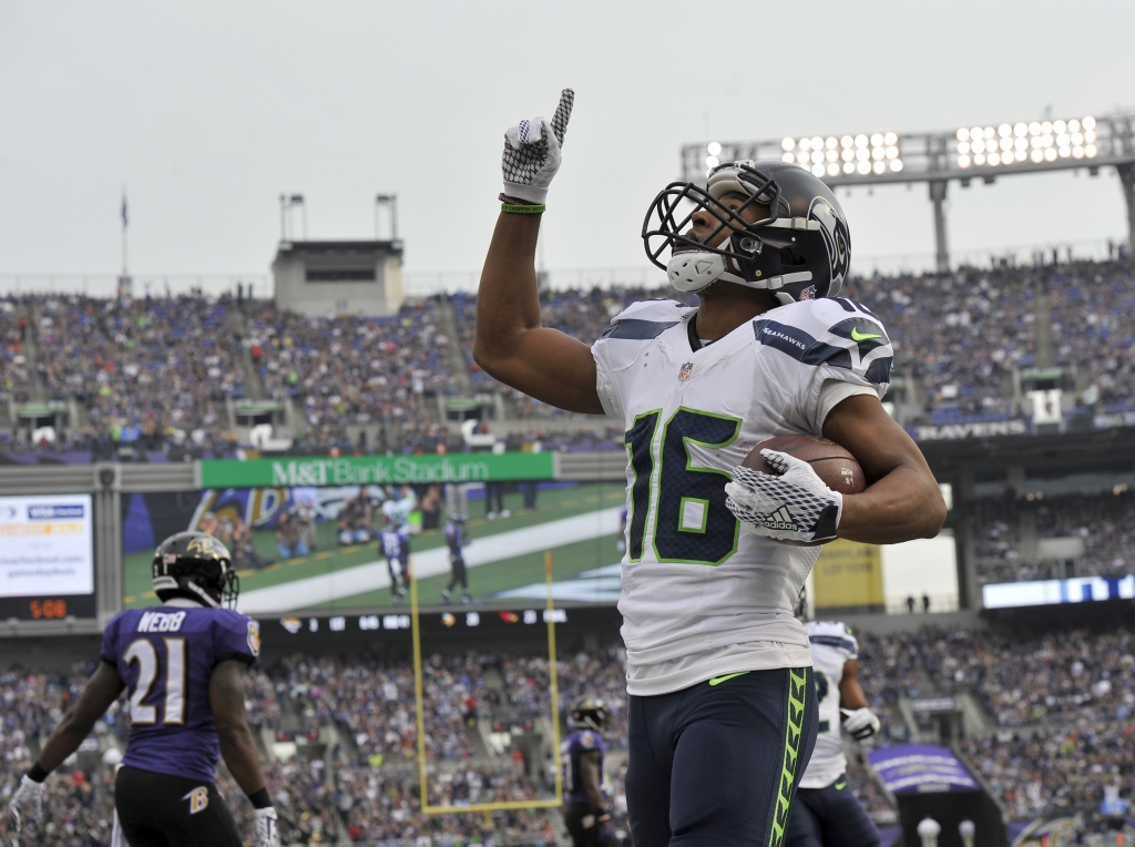 Seattle Seahawks wide receiver Tyler Lockett celebrates his touchdown with Baltimore Ravens cornerback Lardarius Webb nearby during the first half an NFL football game Sunday Dec. 13 2015 in Baltimore