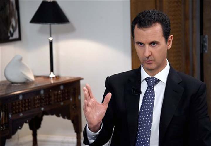 Syrian official news agency SANA shows Syrian President Bashar Assad speaks during an interview with the Spanish news agency EFE in Damascus Syria Friday Dec. 11 2015. Assad said in the interview that Saudi Arabia the