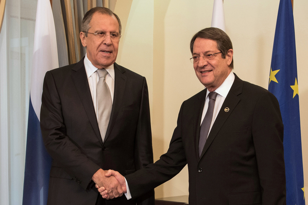 Russian Foreign Minister Sergey Lavrov left and Cyprus President Nicos Anastasiades shake hands before their meeting at the presidential palace in Nico