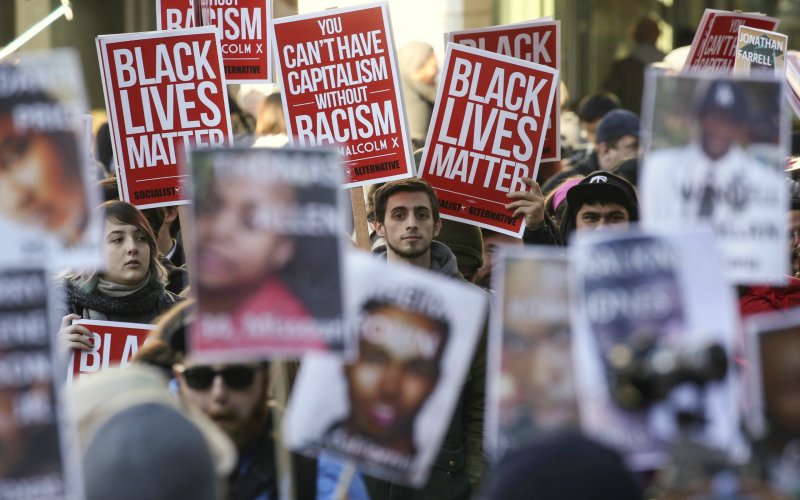 Black Lives Matter protesters gather in Westlake Park near Westlake Mall during Black Friday in Seattle Washingt