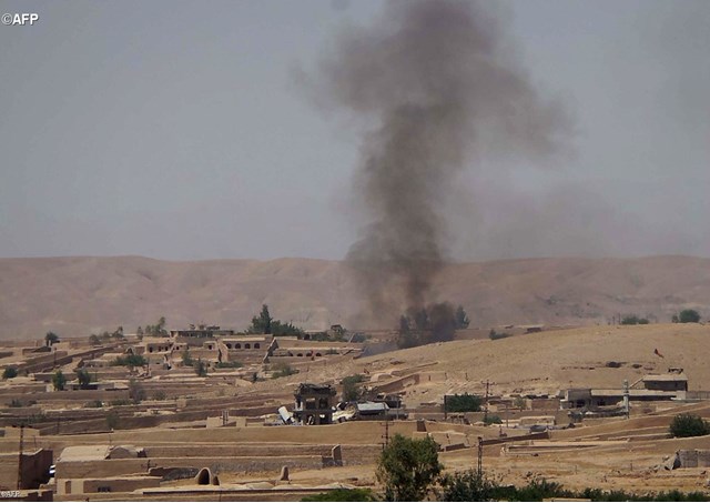 Smoke rises over the Sangin district of Afghanistan following fighting in June 2014. The region continues to be unstable and is now possibly under Taliban control.- AFP