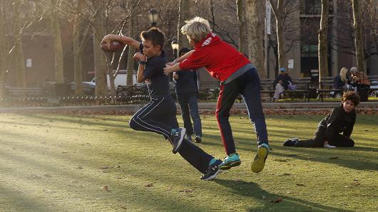 Young boys play in a park during an unusually warm winter day in the Brooklyn borough of New York