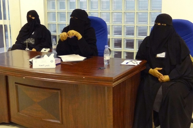 Saudi election officials sit at a polling station in the Saudi capital Riyadh