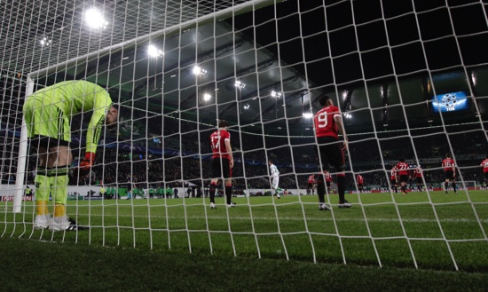 Manchester United’s goalkeeper David de Gea stands inside the goal after Wolfsburg’s Naldo scored his side’s third goal during the Champions League group B soccer match between VfL Wolfsburg and Manchester United