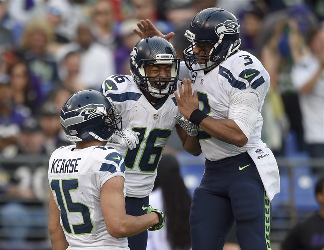 Seattle Seahawks wide receiver Jermaine Kearse watches as Seahawks wide receiver Tyler Lockett and Seahawks quarterback Russell Wilson celebrate connecting for a touchdown during the second half an NFL football game against the Baltimore Rav