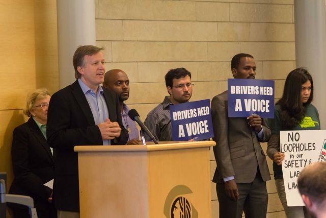 Seattle City Councilmember Mike O'Brien speaking at an October event in support of his bill to allow Uber and Lyft drivers to unionize