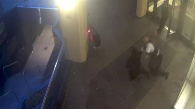 In this still image taken from security video footage security guard Nathaniel Mc Neil tackles a machete-wielding man following what police believe was an unprovoked attack in Toronto on Wednesday