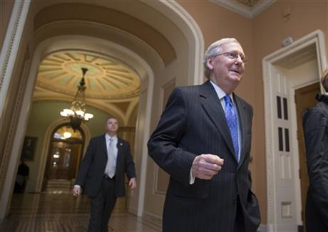 Senate Majority Leader Mitch McConnell R-Ky. walks from the chamber as Republicans pushed legislation toward Senate approval that would demolish President Barack Obama's signature health care law and halt Planned Parenthood's federal money