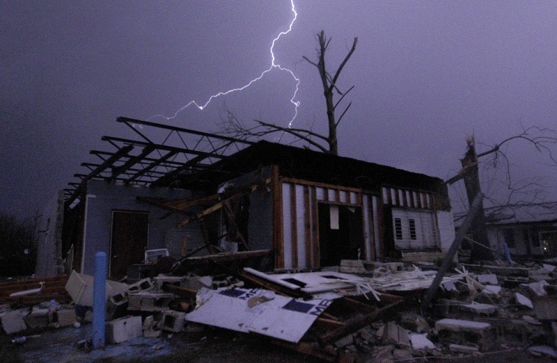 Lightning illuminates a house after a tornado touched down in Jefferson County Ala. damaging several houses Friday Dec. 25 2015 in Birmingham Ala. A Christmastime wave of severe weather continued Friday