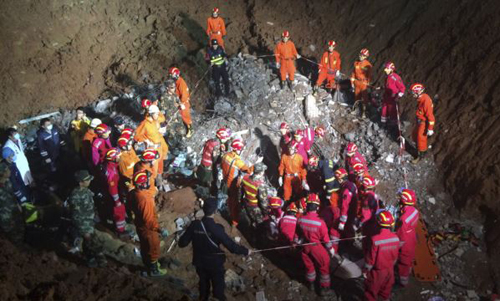 Rescuers surround the area where they found a survivor under a collapsed building at the site of a landslide that hit an industrial park on Sunday in Shenzhen Guangdong province China on Dec. 23 2015. /Reuters