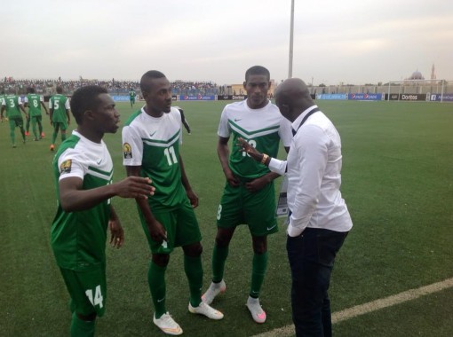 Siasia dishes out instructions to three of his boys during the match