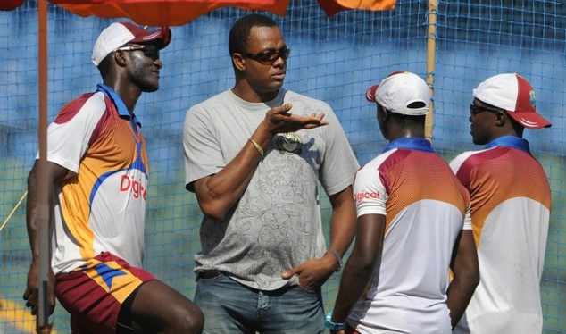 Former West Indies cricketer Courtney Walsh speaks with team players during a practice session at The Wankhede Stadium in Mumbai