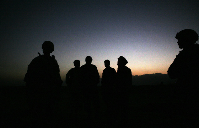 U.S. Army soldiers stand with Afghan policemen before a joint patrol of Qalanderkhail outside of Bagram Air