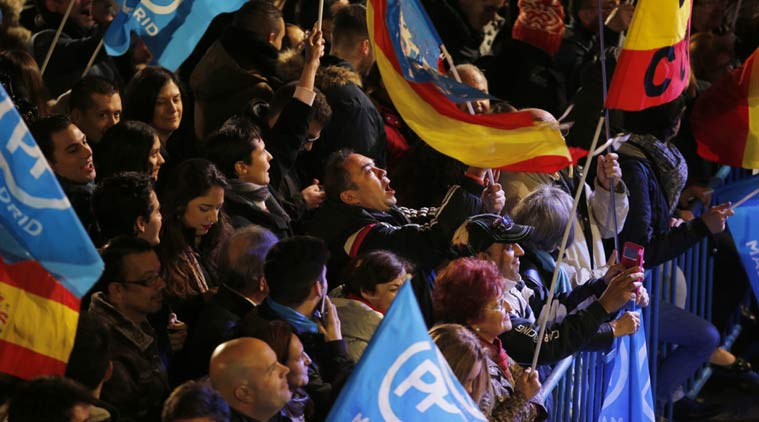 Popular Party supporters shout slogans outside the party's headquarters following the national elections in Madrid Sunday Dec. 20 2015