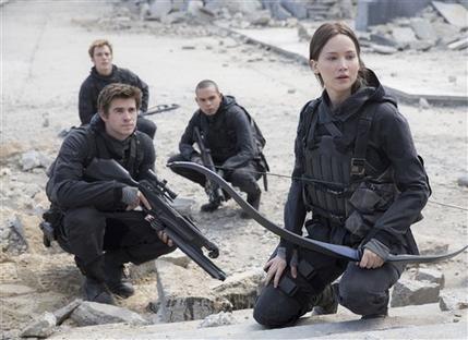 Liam Hemsworth left Sam Clafin left in the background Evan Ross right at the bottom and Jennifer Lawrence right in the film'The Hunger Games Mockingjay- Part 2