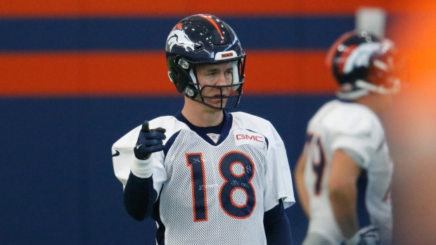 Peyton Manning warms up during practice