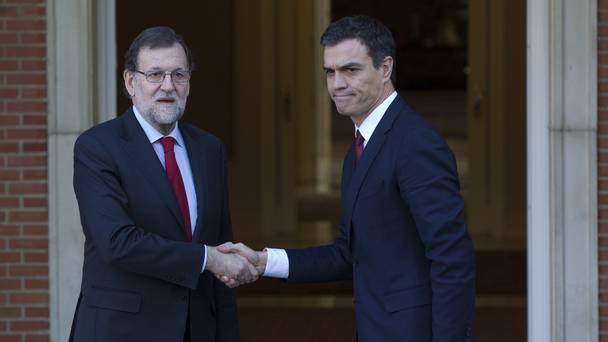 Spain's acting PM Mariano Rajoy left shakes hands with Socialist opposition leader Pedro Sanchez as the pair met for talks