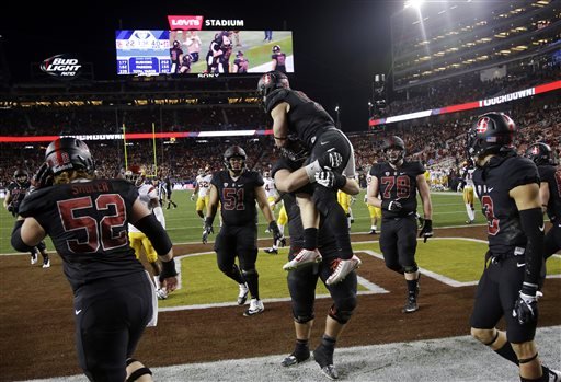 Stanford running back Christian McCaffrey center is lifted by a teammate after scoring on a 10-yard run against Southern California during the second half of a Pac-12 Conference championship NCAA college football game Saturday Dec. 5 2015 in Santa Cl