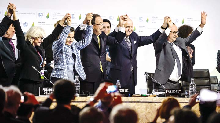 TRIUMPH FOR MOTHER EARTH – Moments after announcing the finalization of the World Climate Change Conference 2015 final agreement French President Francois Hollande and United Nations Secretary General Ban Ki Moon lead other con