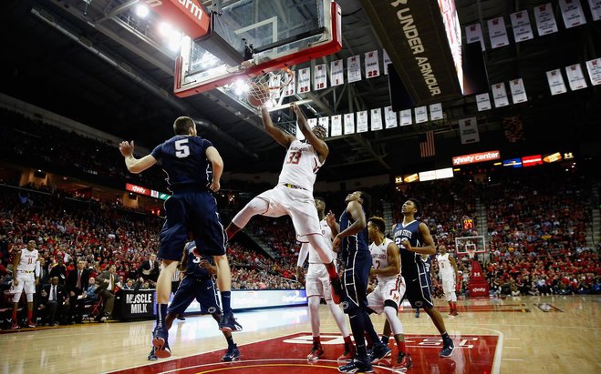 Diamond Stone of the Maryland Terrapins dunks over Donovon Jack of the Penn State Nittany Lions