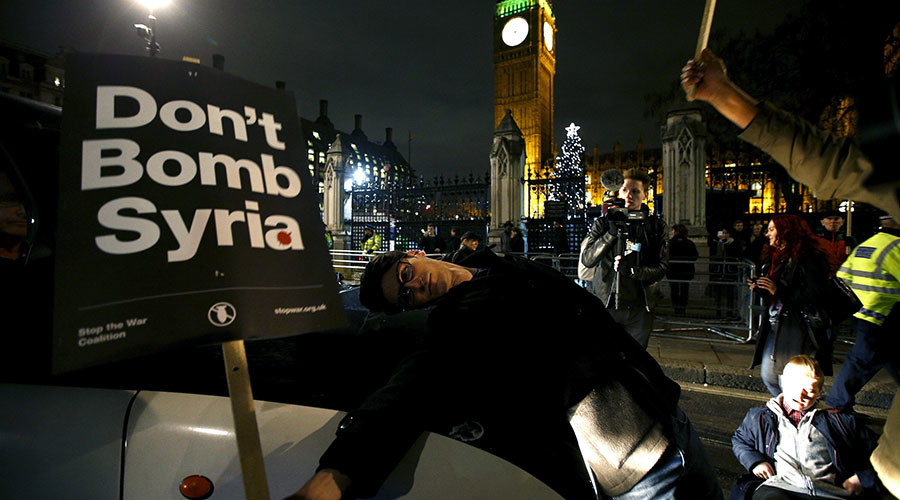 Anti-war protestors stop a taxi as they block the road during a demonstration outside the Houses of Parliament in London Britain