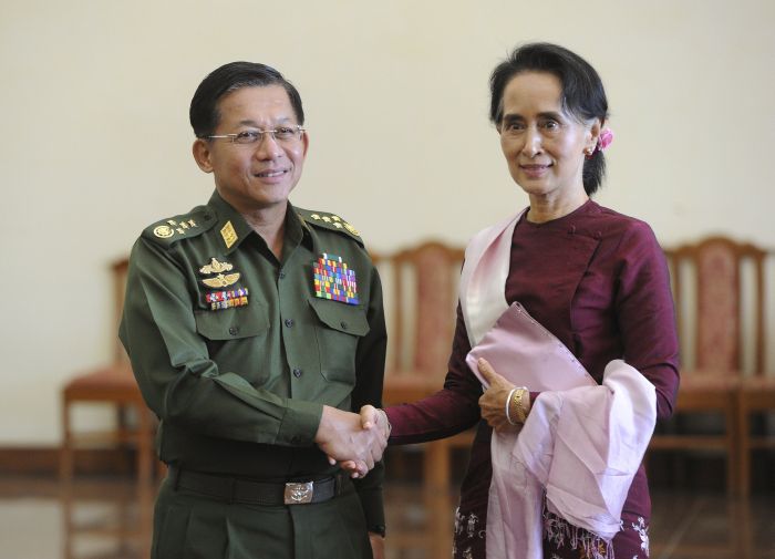 Myanmar's Commander-in Chief Min Aung Hlaing and National League for Democracy party leader Aung San Suu Kyi shake hands after their meeting in Naypyitaw