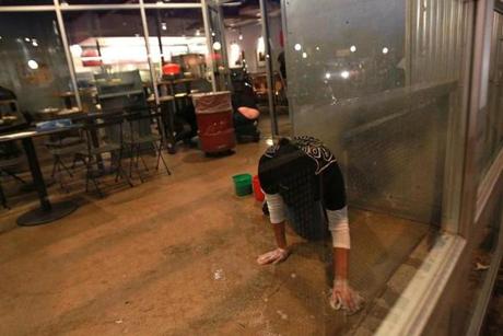 Workers cleaned the closed Chipotle Restaurant in Cleveland Circle