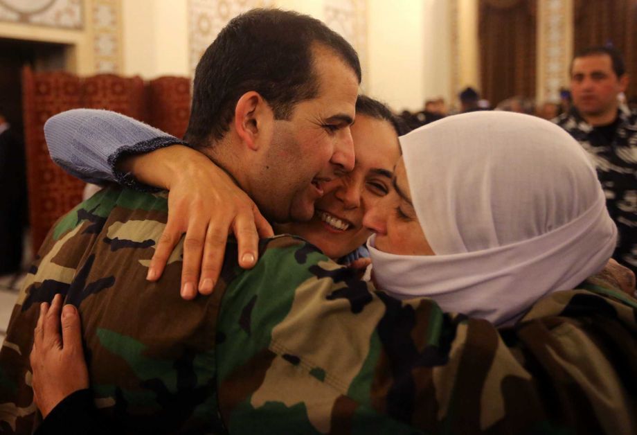 A Lebanese army soldier who was kidnapped by Nusra Front﻿ is hugged by his mother and sister ﻿Tuesday in Beirut Lebanon﻿. The﻿ captives had been held for more than a year