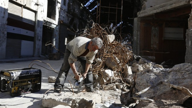 Repairing damaged shops at the covered market in the old city of Homs Syria on Tuesday. Once Syrian opposition fighters start pulling out of the last rebel-held area of Homs this week the city once known as the'capital of the revolution will return