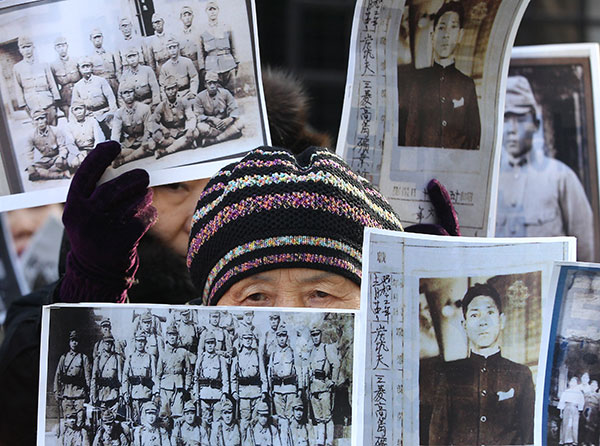 A South Korean woman whose family members were killed by Japanese forces during World War II attends a rally in Seoul on Monday demanding full compensation and an apology from the Japanese government