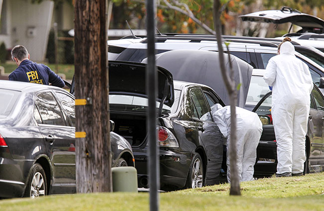 CALIFORNIA. FBI agents investigate a car near a home in connection to the shootings in San Bernardino Thursday Dec. 3 2015 in Redlands California