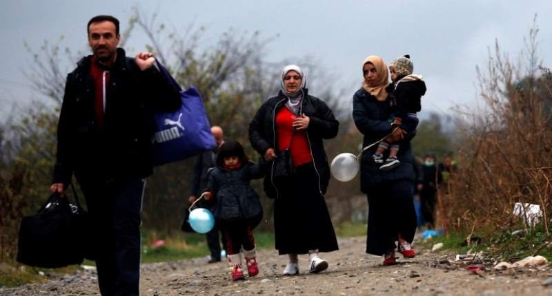 Migrants walk after crossing the border from Greece into Macedonia near Gevgelija Macedonia on Nov. 25 2015