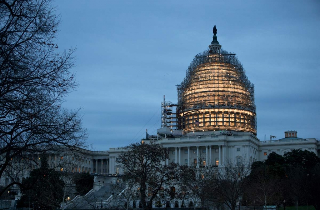 The Capitol Dome is illuminated amid scaffolding for repairs in Washington Friday morning Dec. 18 2015