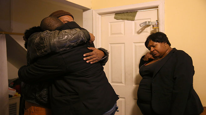 Melvin Jones facing camera hugs Robin Andrews both brothers of Bettie Jones 55 in Jones&#039 living room after she was shot and killed by a Chicago police officer in Chicago on Saturday Dec. 26 2015. A Chicago police officer shot and killed Jones