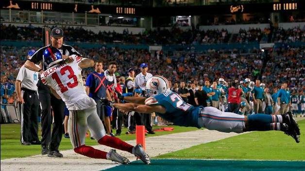 MIAMI GARDENS FL- DECEMBER 14 Odell Beckham #13 of the New York Giants catches a touchdown pass as Brent Grimes #21 of the Miami Dolphins defends during the third quarter of the game at Sun Life Stadium