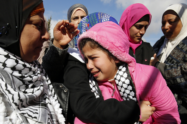 The daughter of Mahdiyya Hammad cries during her mother's funeral