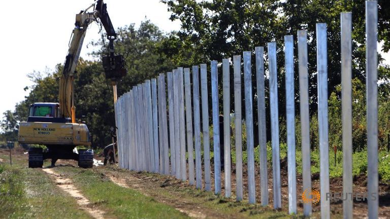 The poles of a new fence on the border with Croatia are set up near Beremend Hungary