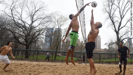 The shirts come off on Christmas Eve as a group plays volleyball in New York's Central Park