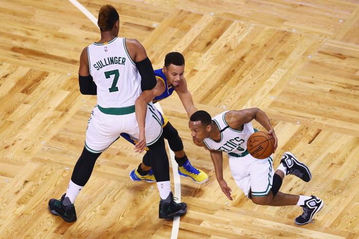 BOSTON MA- DECEMBER 11 Avery Bradley #0 of the Boston Celtics drives against Stephen Curry #30 of the Golden State Warriors who is defended by Jared Sullinger #7 during the first quarter at TD Garden