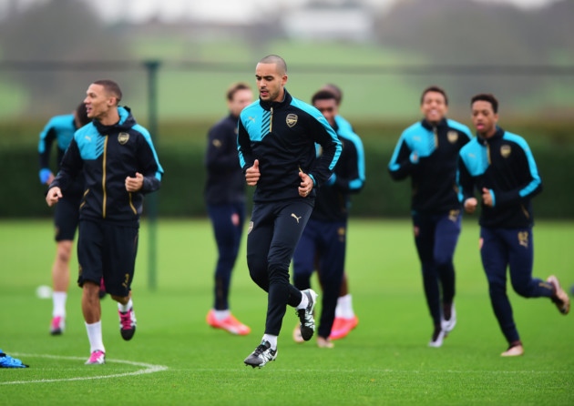 Theo Walcott of Arsenal warms up with team mates