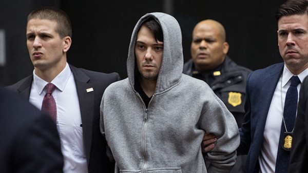 Martin Shkreli the former hedge fund manager under fire for buying a pharmaceutical company and ratcheting up the price of a life-saving drug is escorted by law enforcement agents in New York Thursday Dec. 17 2015 after being taken into custody follo